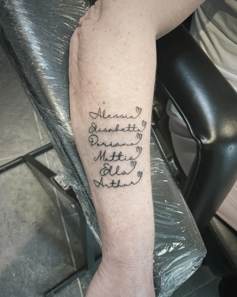 Names with hearts tattoo, an elegant script with small hearts to emphasize the special bond between grandparent and grandchildren