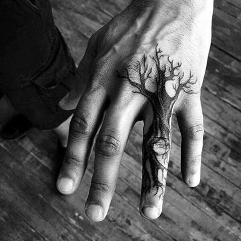 Blackout hand tattoo for men, showcasing bold ink application