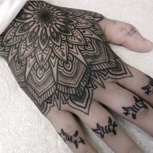 Detailed geometric hand tattoo for men