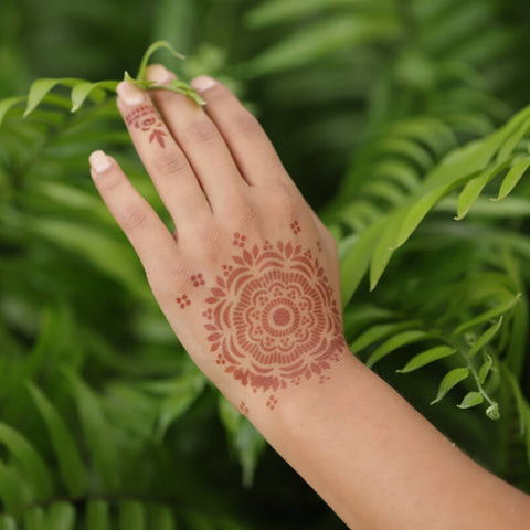 Mandala henna tattoo on back of hand