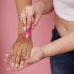 Applying coconut oil to a henna tattoo