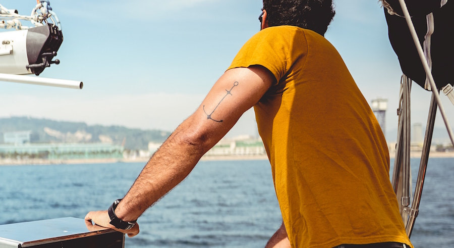 Fresh tattoo on arm healing, depicting the importance of waiting before saltwater exposure