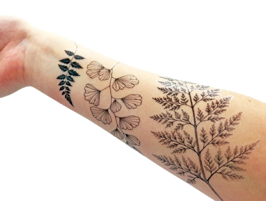 Woman applying a temporary tattoo to her arm after preparing the skin with alcohol
