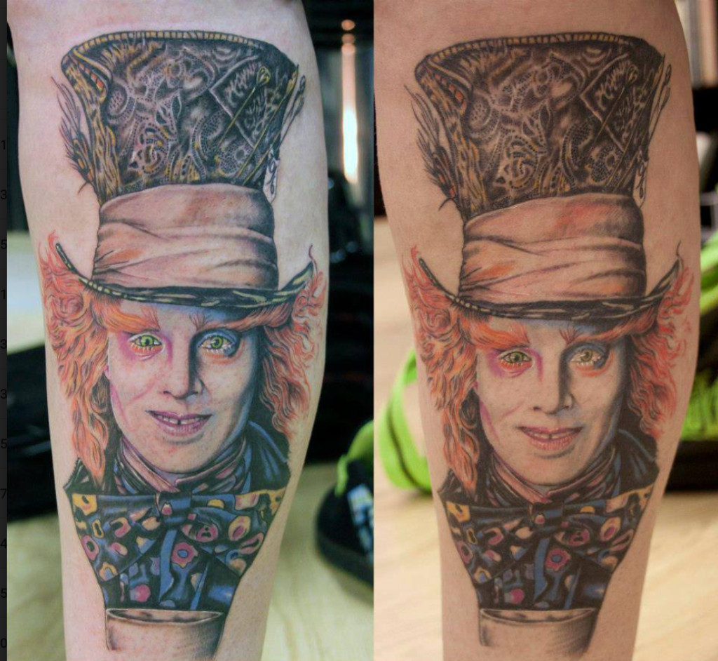 A person touching up their faded tattoo.