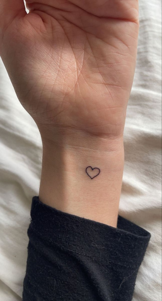 Tiny heart wrist tattoo symbolizing love and affection