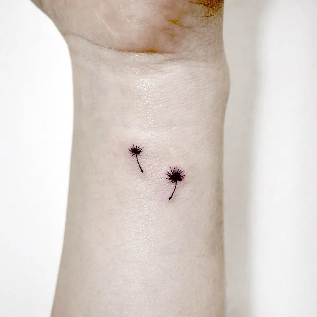 Dandelion wrist tattoo symbolizing wishes and dreams