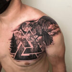 A dramatic tattoo depicting one of Odin’s ravens, either Huginn or Muninn, in mid-flight in front of a forest-themed Valknut.