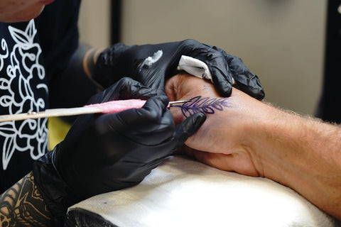 Hand poke tattoing