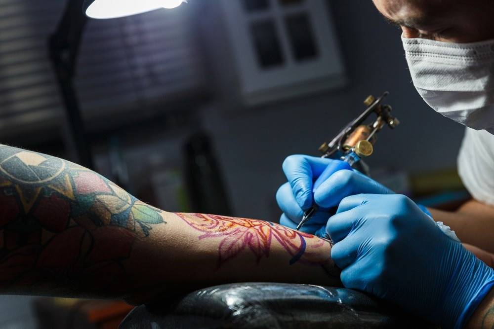 Close-up of a tattoo infection with redness and swelling