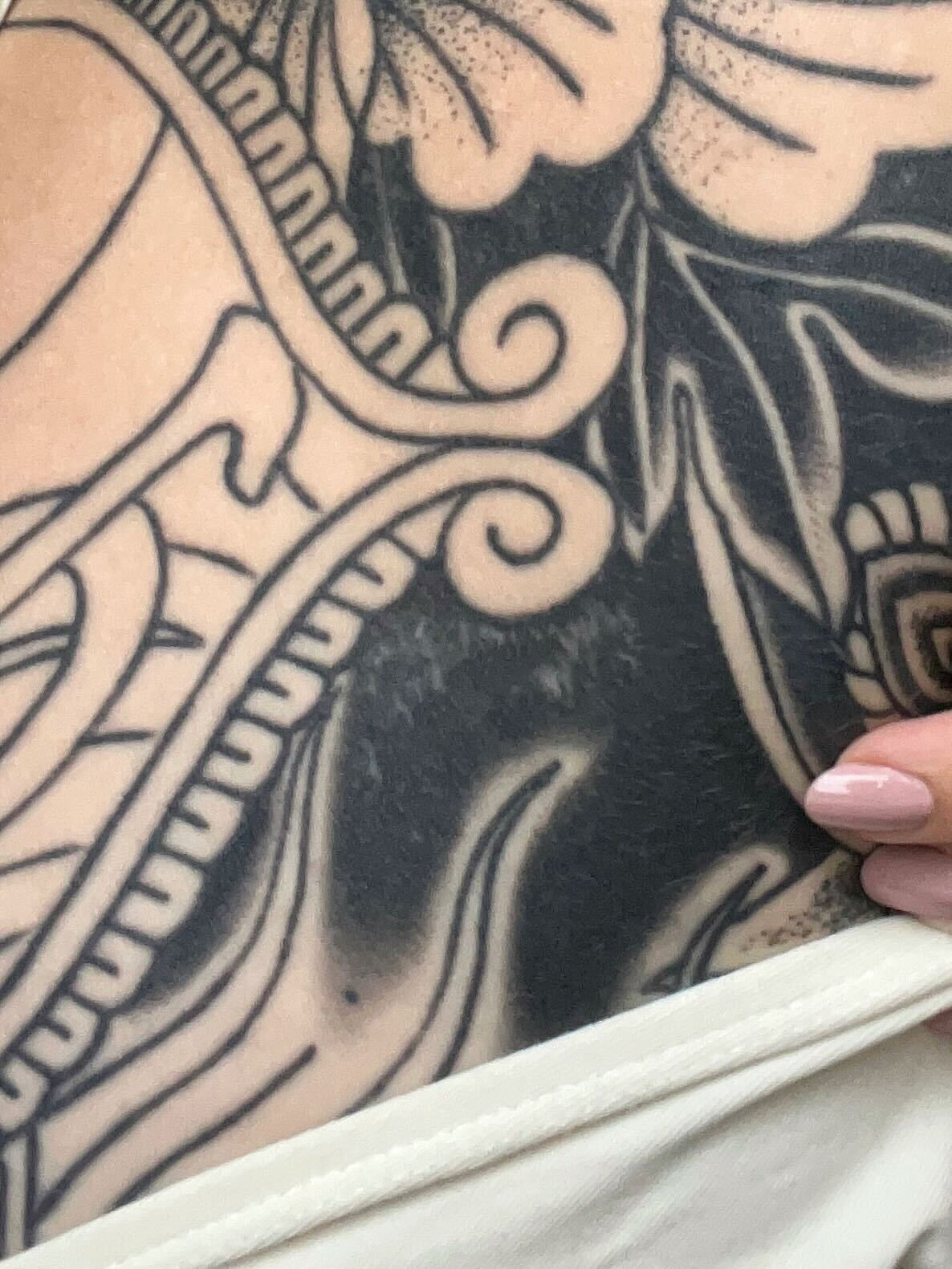Black and grey tattoo on a person's arm