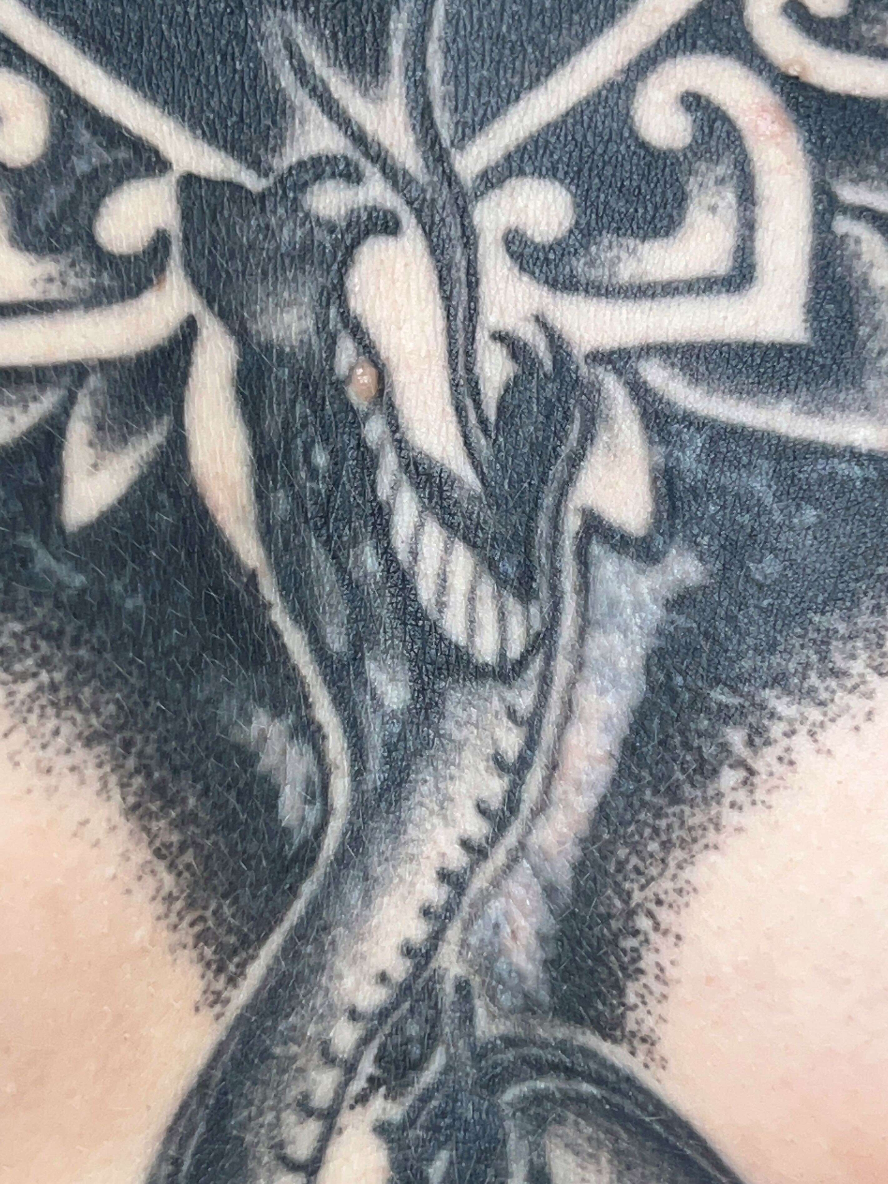 Traditional tattoo after the healing process, showing the faded ink