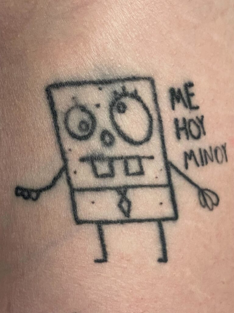 Tattoo blowout example, showing ink bleeding and blurring around the edges, potentially caused by incorrect needle depth or pressure during the tattooing process.