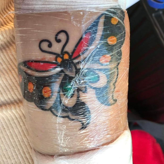 A close-up of a tattoo being gently washed with mild soap and water, highlighting the importance of proper hygiene.