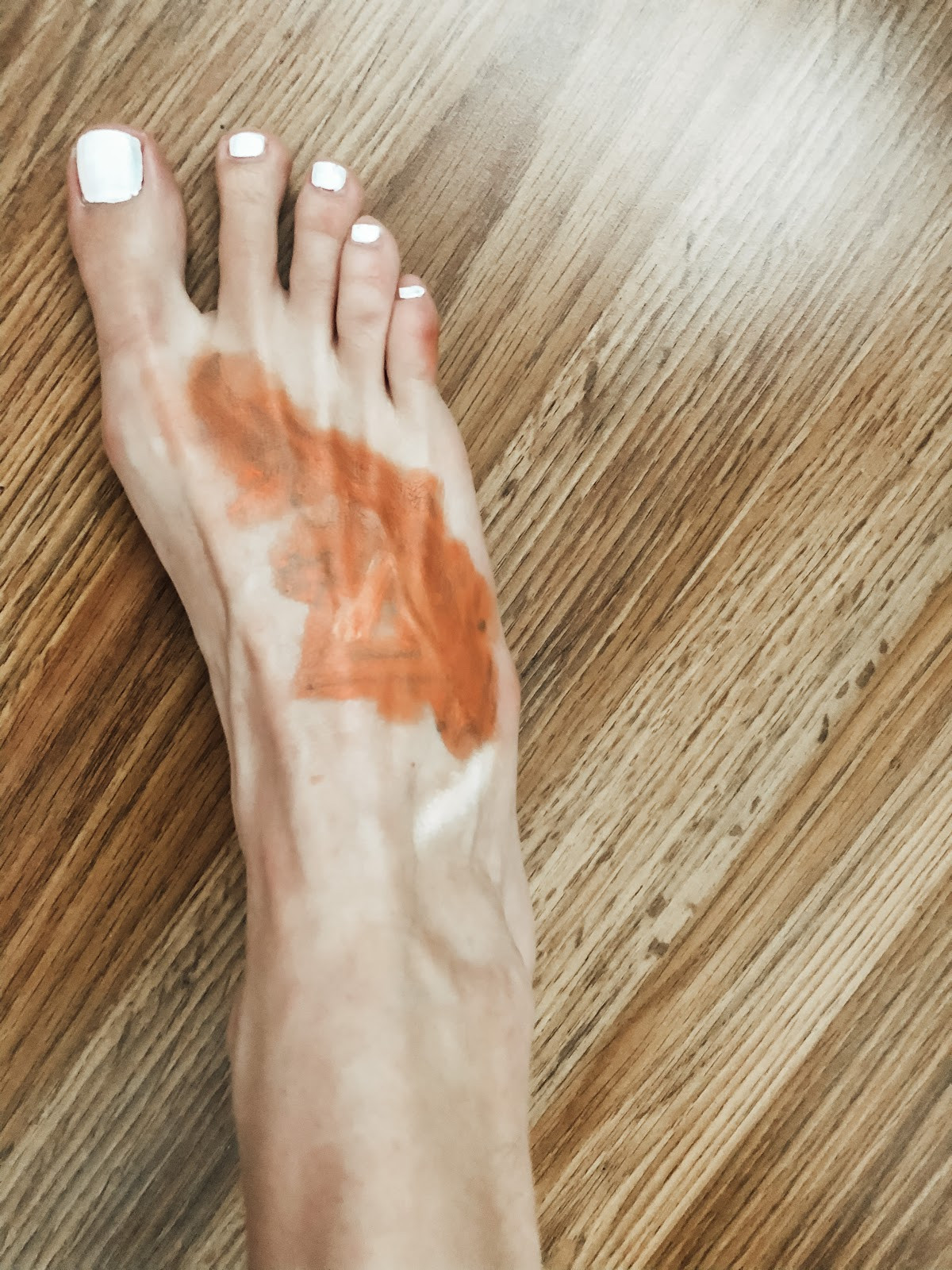 Applying color corrector on tattoo