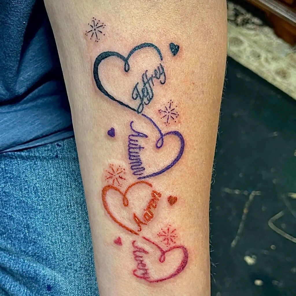 Interconnected hearts with names tattoo, symbolizing individuality and unity within the family with vibrant colors and whimsical stars