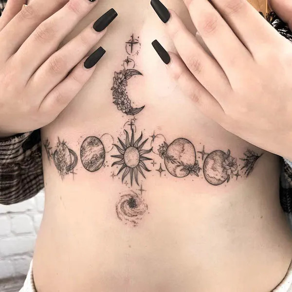 Intricate floral planets underboob tattoo blending cosmic elements.