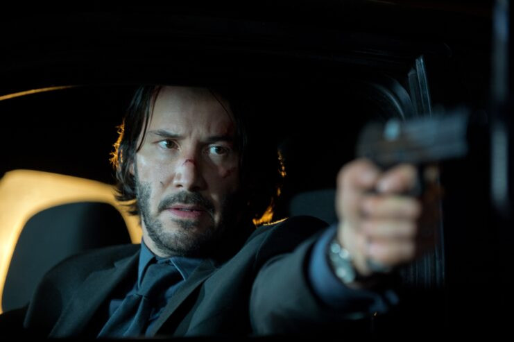 John Wick's tactical watch wearing style indicating military affiliation