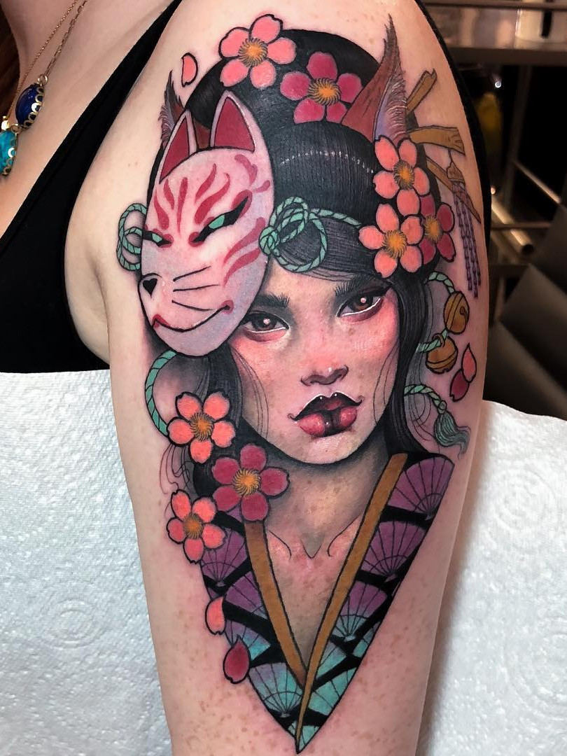 A detailed black and grey Japanese cherry blossom tattoo cascading down the back of a person.