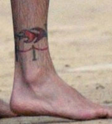 Justin Timberlake's ankle tattoos, including the NSYNC flame and velvet ropes, symbolizing his success with the band.