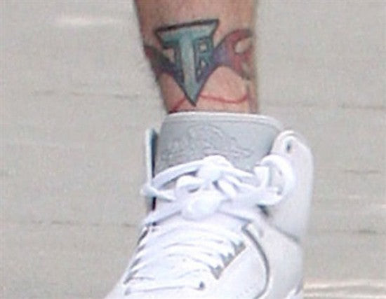 Justin Timberlake's ankle tattoo featuring his initials J.R.T., commemorating his personal identity within his successful music career.