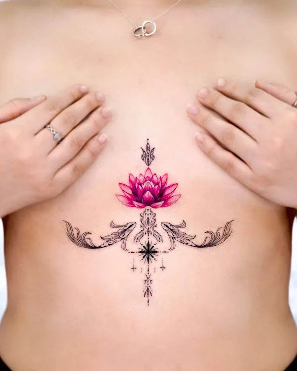 Koi fish and lotus underboob tattoo drawing focus with contrasting colors.