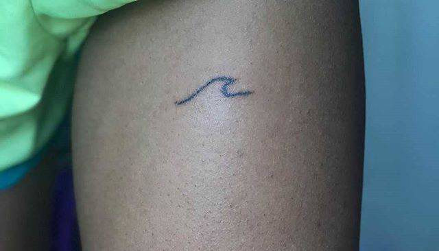 wave tattoo on the thigh