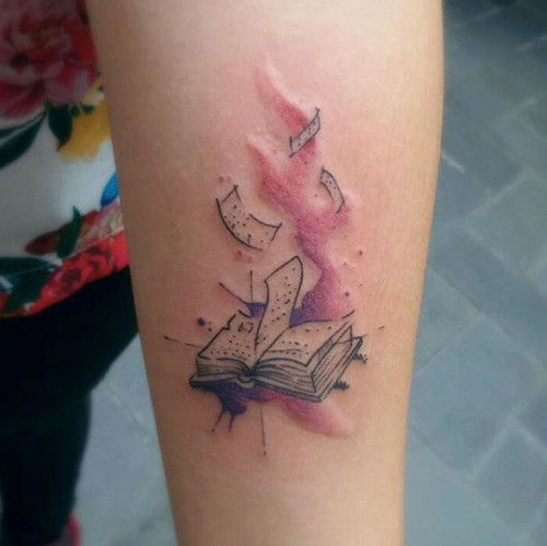 Open book tattoo with world map