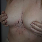 Delicate sternum tattoo featuring planets