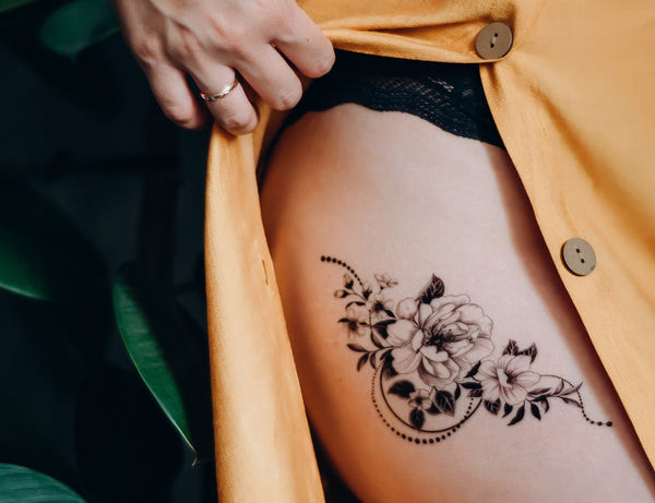 Woman with a thigh tattoo wearing a dress suitable for easy access