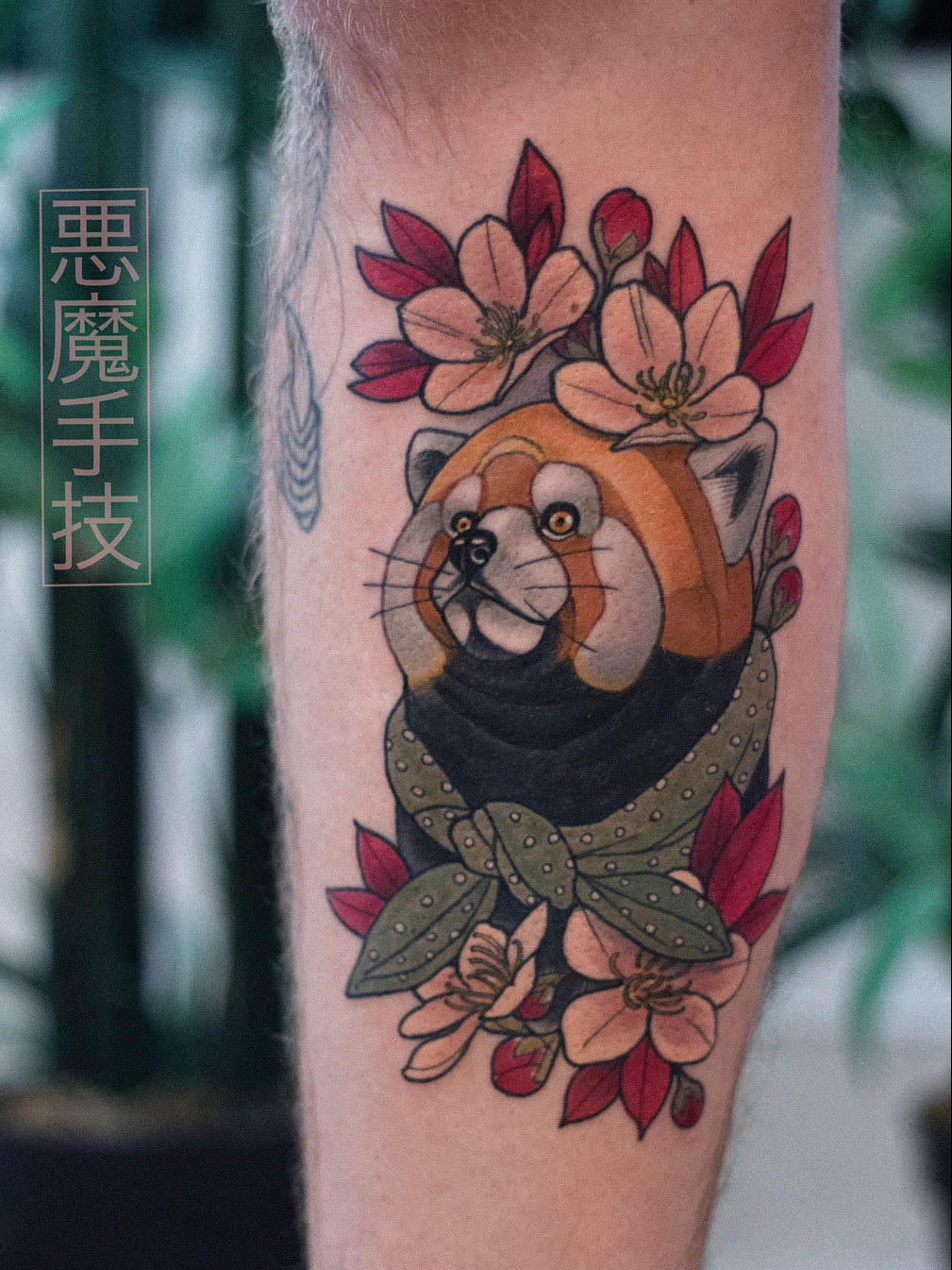 An elegant Japanese cherry blossom tattoo extending along the side of the body in a minimalist style.