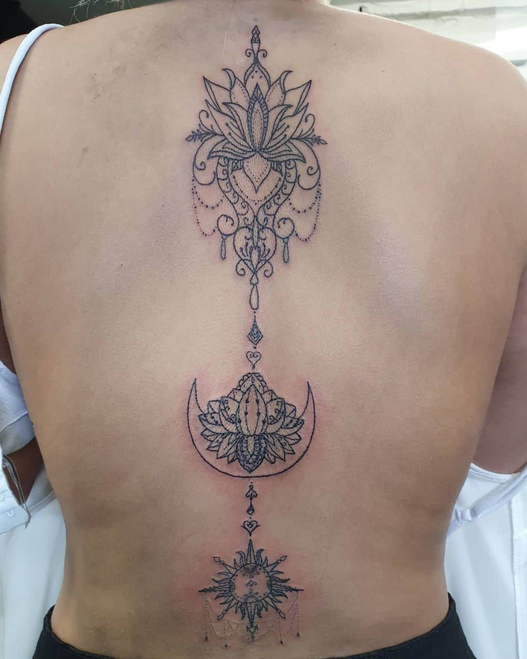 Mandala spine tattoo with intricate detailing