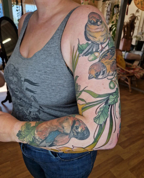 Sleeve tattoo featuring a blend of floral elements and intricate patterns