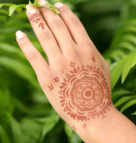 Woman with henna design on her hand.