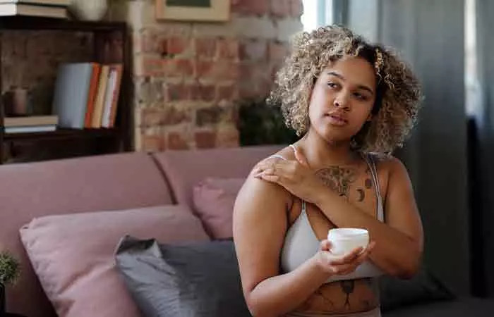 Woman applying CeraVe cream for skin hydration