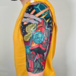Traditional tattoo sleeve with diverse imagery and vibrant colors