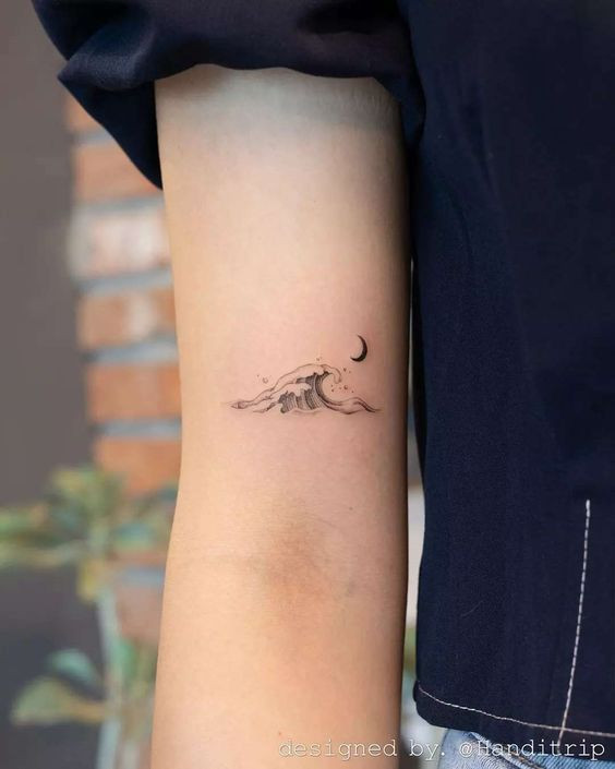 Minimalist wave tattoo on arm near elbow with crescent moon, designed by @Landittrip.