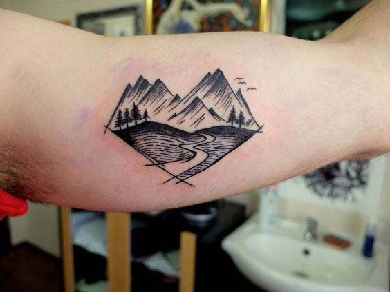 Mountains inner bicep tattoo for men inspired by nature