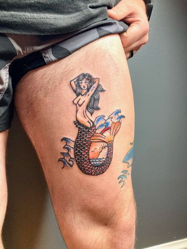 Nude mermaid tattoo on the inner thigh expressing sensuality and confidence