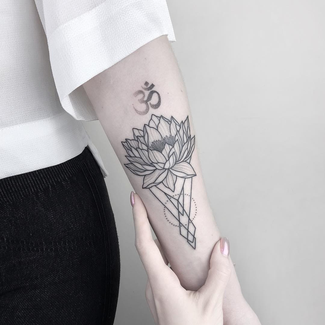 A geometric Buddha tattoo on a man's arm, using dotwork and linework
