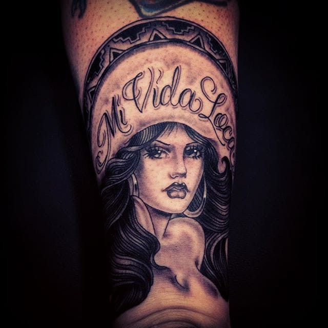 Tattoo by Chuco Moreno featuring a Chicano girl, showcasing fine-line work and cultural pride