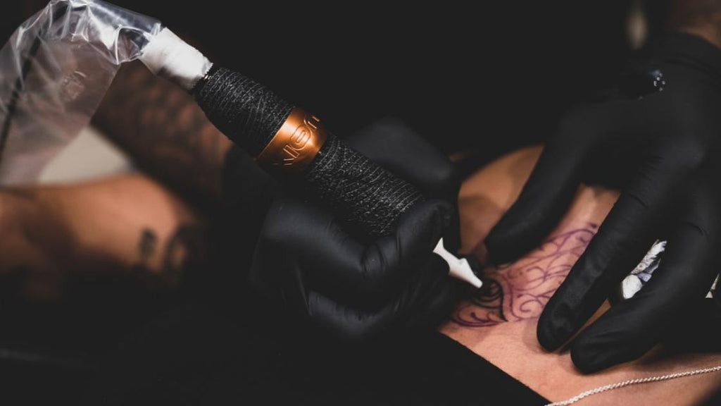 A person busy getting a tattoo.