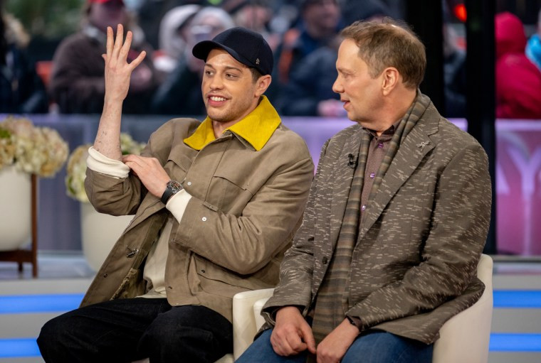 Pete Davidson showing his tattoo-less arm.