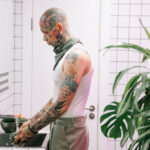 A man routinely washing his new tattoo.