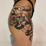 Leaf shapes covering the snake tattoo