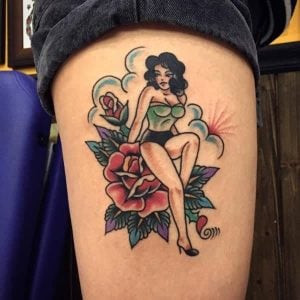 A vintage swallow tattoo on a woman's arm, reminiscent of classic Americana designs.