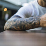 Forearm tattoo pain levels explained, featuring an artistic design