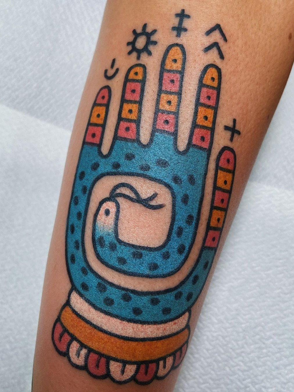 A collage of Buddhist symbol tattoos, including the Om symbol and lotus flower