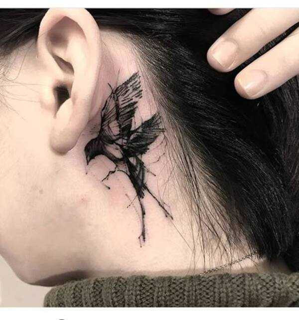 A crow tattoo design placed on the forearm, symbolizing strength and resilience