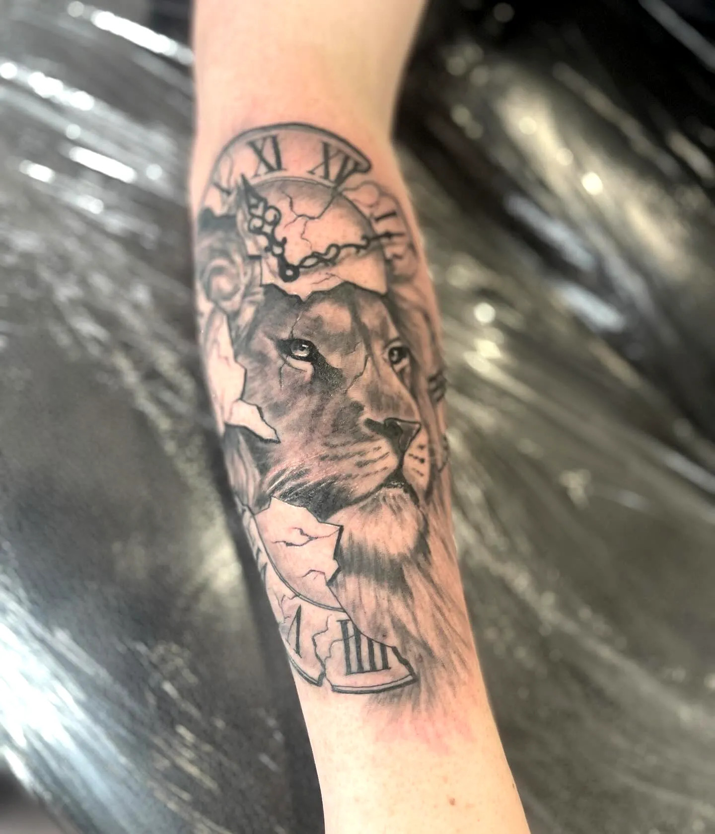 Realistic Black and Gray Broken Clock Lion Face Forearm Tattoo