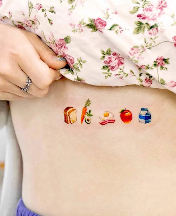 Rib tattoo for foodies featuring colorful food icons, showcasing love for culinary delights.